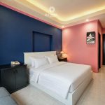 Modern suite with stylish pink and navy interior design at La Casona Hotel Saigon