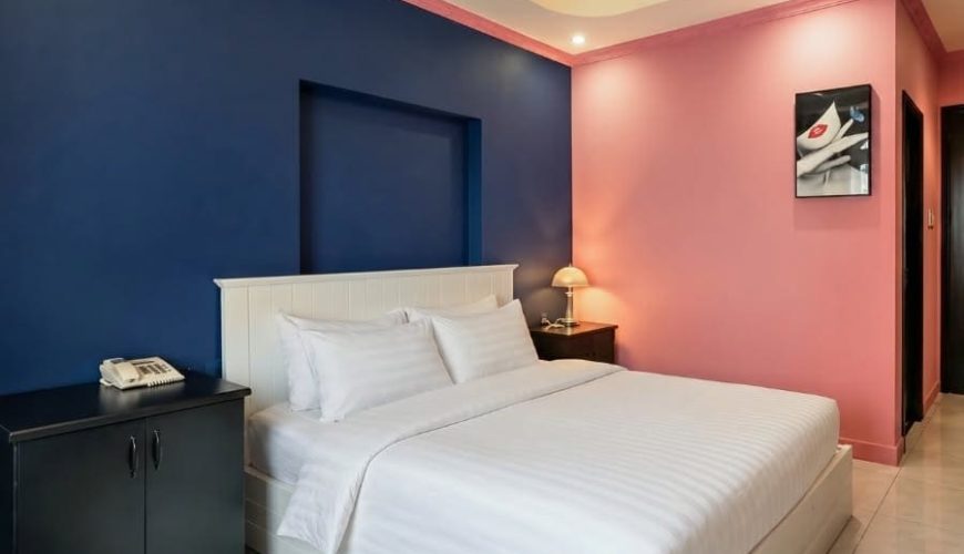 Modern suite with stylish pink and navy interior design at La Casona Hotel Saigon